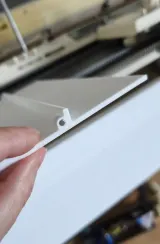 Snapping the lower front bed cover onto the needle bed
