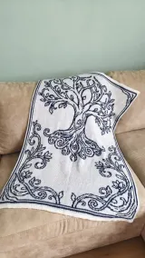 Knitted blanket with the Celtic tree of life design in navy and white jacquard