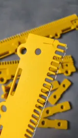 Close-up of the yellow cast-on comb end with hanging holes