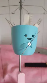 Cute tool organizer clamped to the yarn mast of a knitting machine