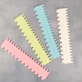 Ribbing needle selector tools in pink, yellow, blue and white