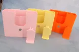 Tool organizers in pink, yellow and orange with clamps