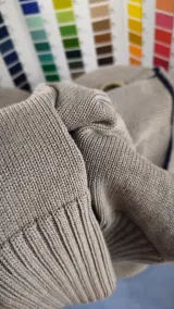 Knitted sweater sleeve in grey beige melange yarn