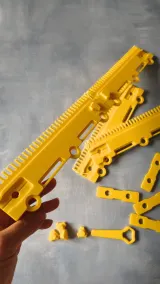Assembled yellow cast-on comb held in hand