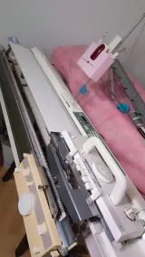 Upper back bed cover with the carriage on a Brother knitting machine