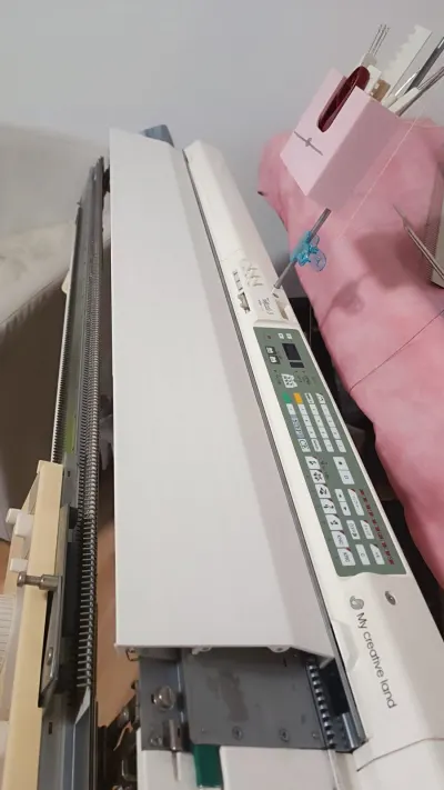 Upper back needle bed cover on a Brother 5gg electronic knitting machine